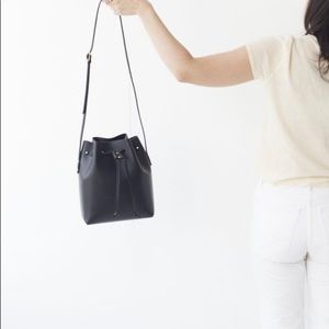 The STOWE Brady Bucket Bag (Black with brass hardware)